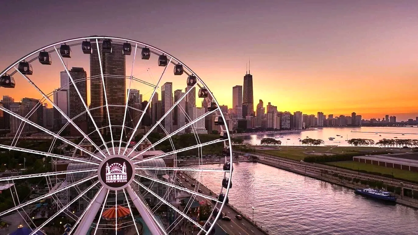 Chicago Ferris wheel at sunset with downtown skyline reflected in river at dusk