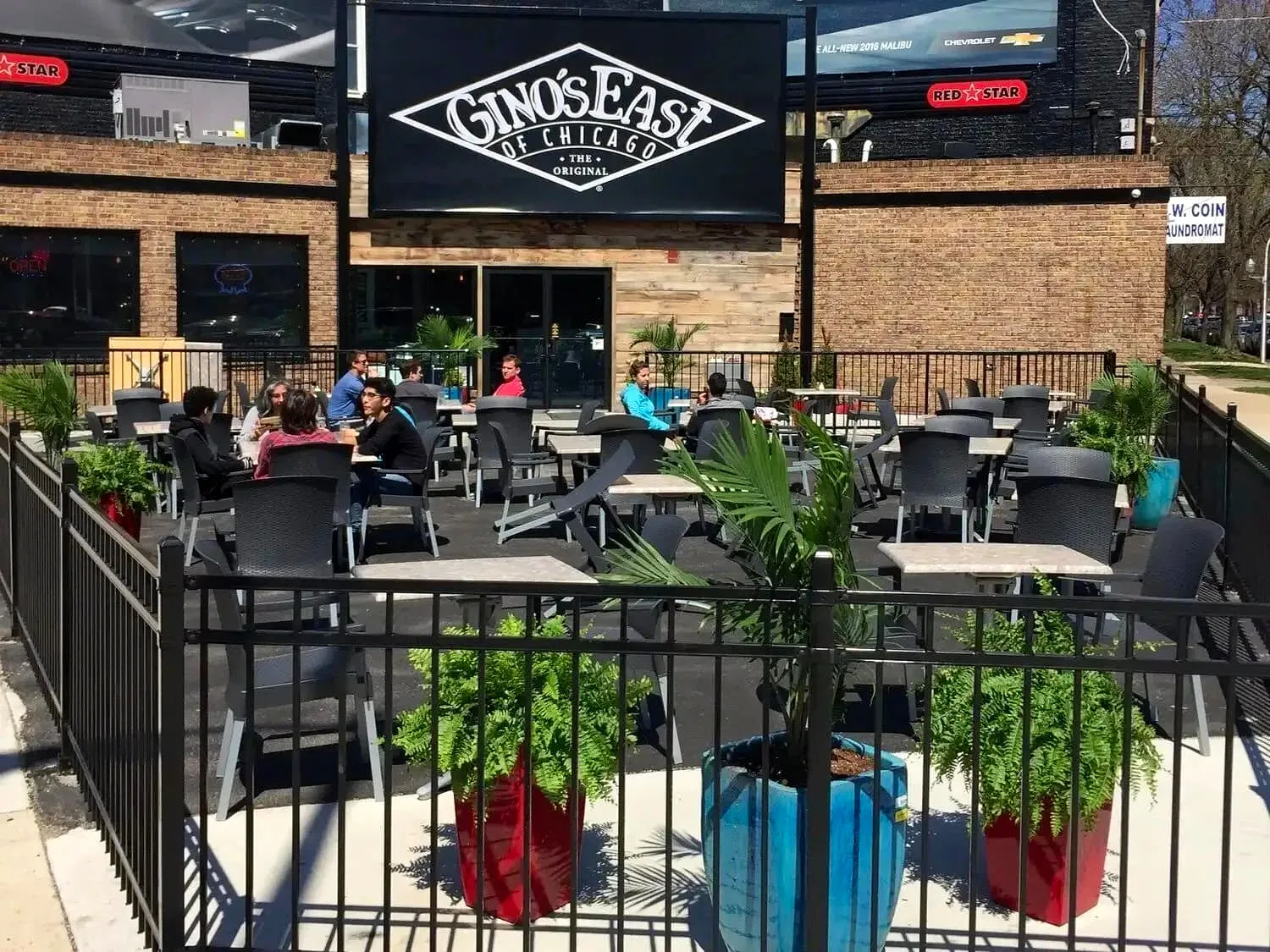 Gino’s East restaurant exterior with storefront sign and outdoor patio seating